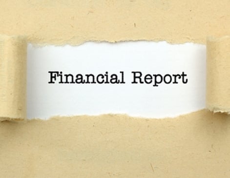 torn paper revealing the words "financial report"