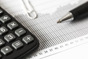 a calculator and balance sheet