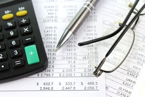 accounting reports on a table with a pen and calculator