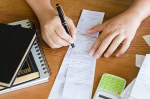 an accountant checking a receipt, one of many common accounting tasks