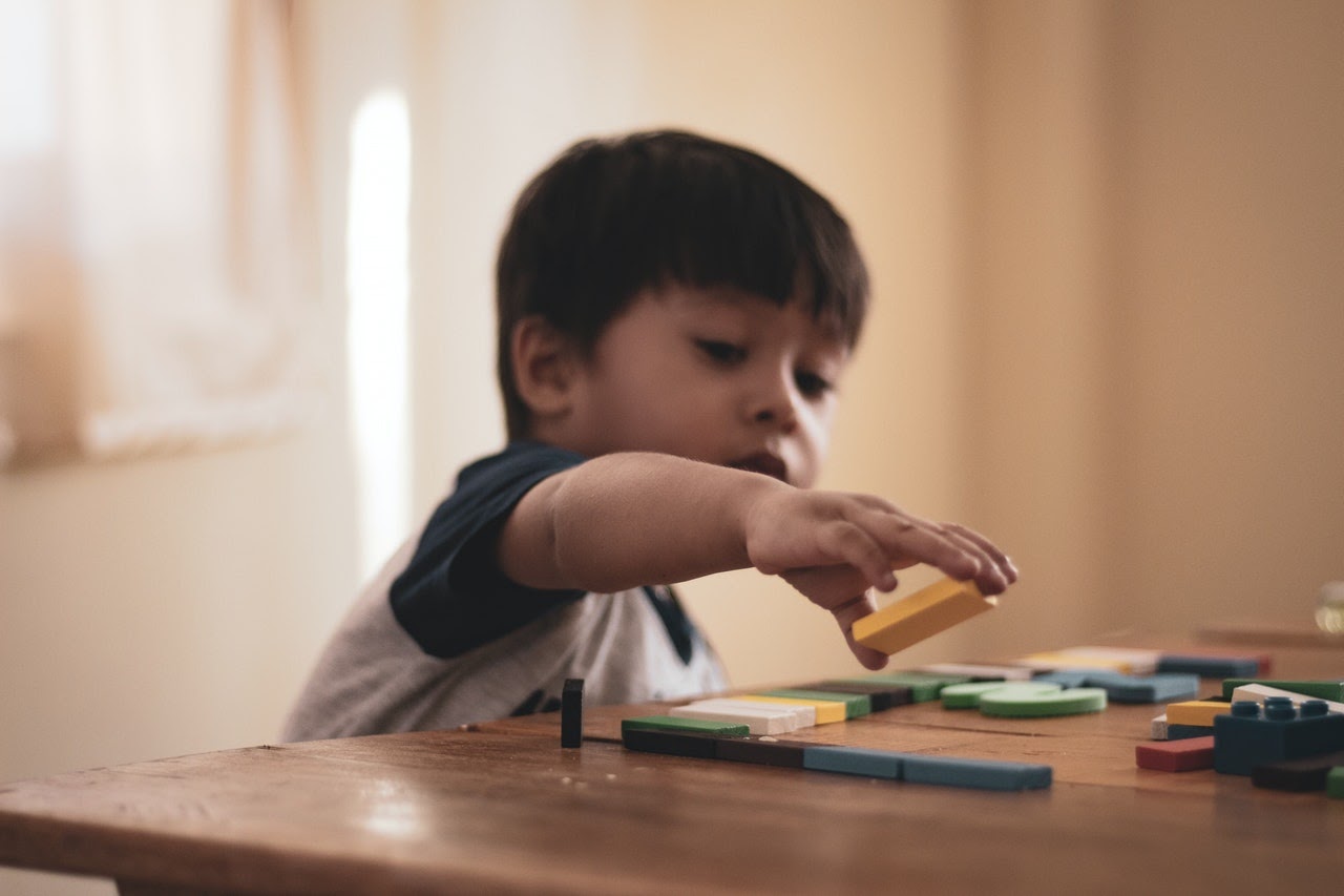 child playing with colorful blocks